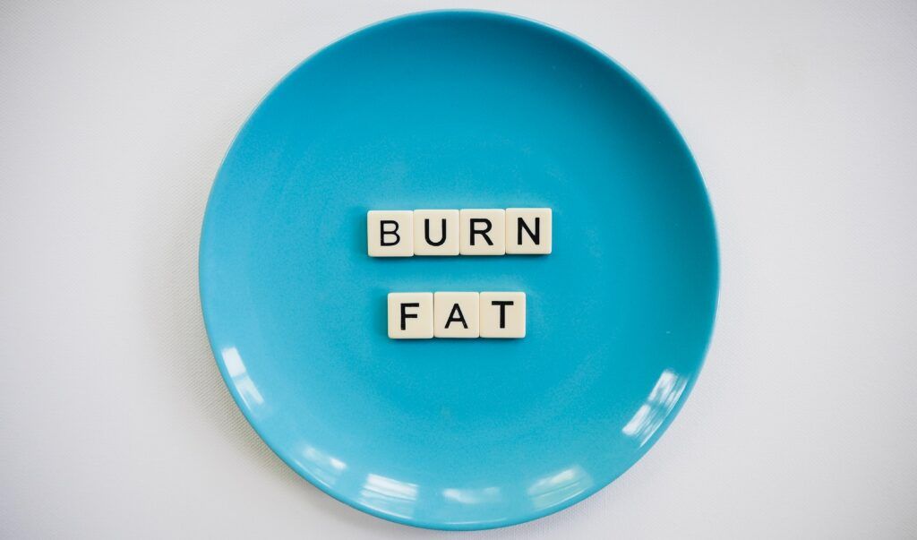  How to Run for Weight Loss a plate with burn fat written on