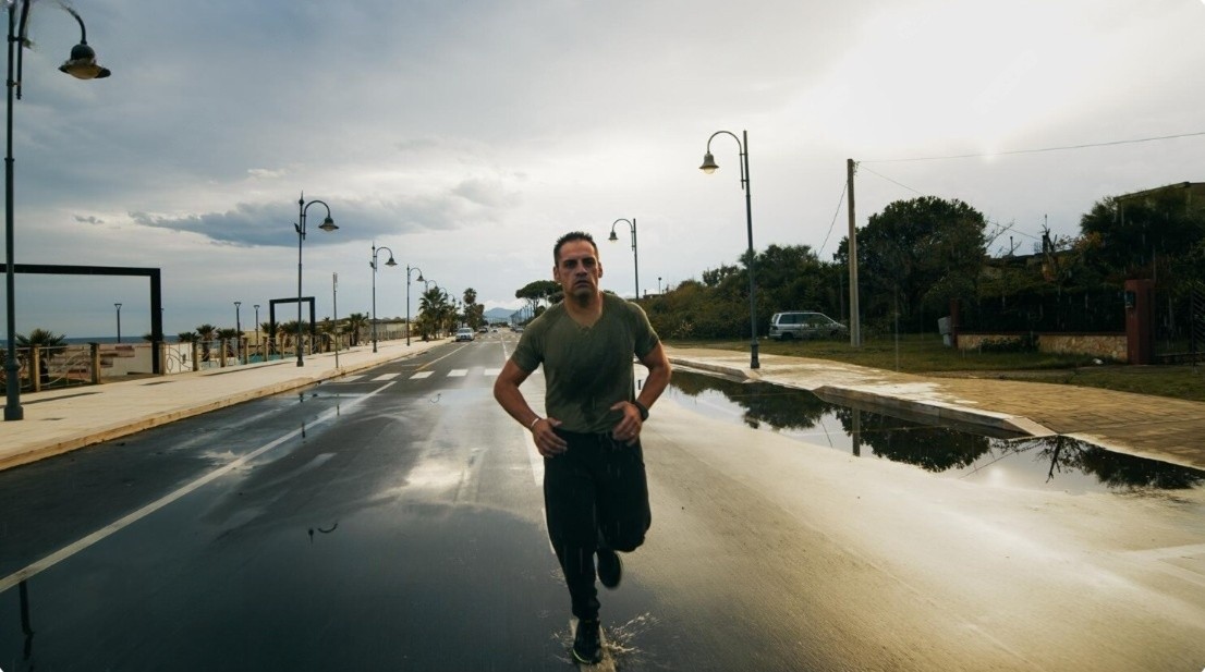 Determined runner training outdoors in rainy weather