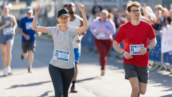 Runner participating in a public race with spectators cheering