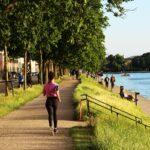 finish a marathon Woman runnig endurance training along a city lake
