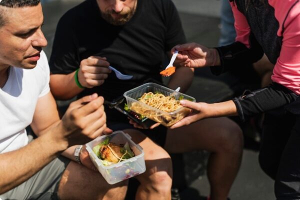 glycogen storage - group of runners eating a carb rich meal