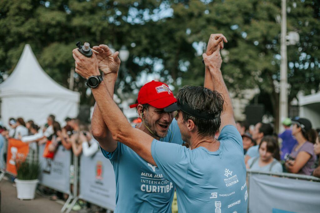 How-to focus-on-recovery-after-run - important-growth-two-runners-cheers-after-finish-line