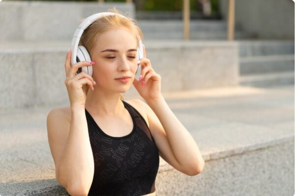 Set Running Goals - A person sitting with headphones, daydreaming