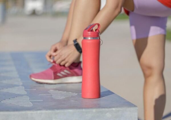 a runners diet - bottle of water on a bench in front of a runner