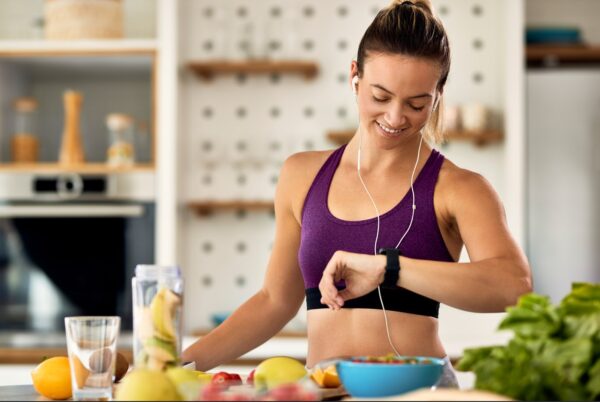 a runners diet - runner checing her wristwatch before eating