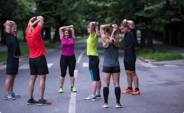 how to start running - a small running group stretching before a club run