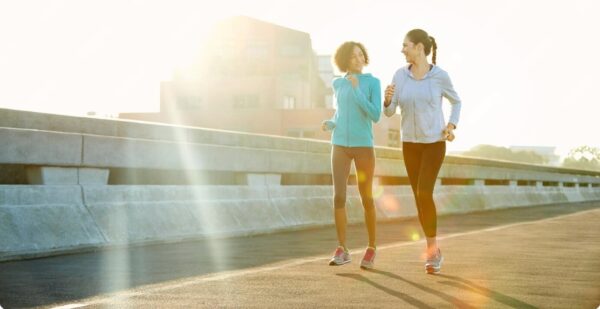 how to start running - two beginner runners jogging together in the early morning