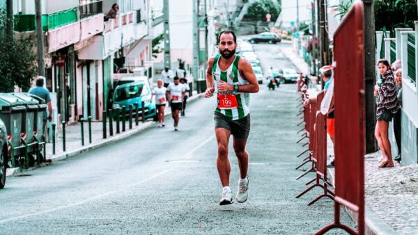 10 Instructive Ways For Marathon Training Progress man in a marathon race running uphill