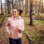 Borg scale - young woman in sportswear running in woods