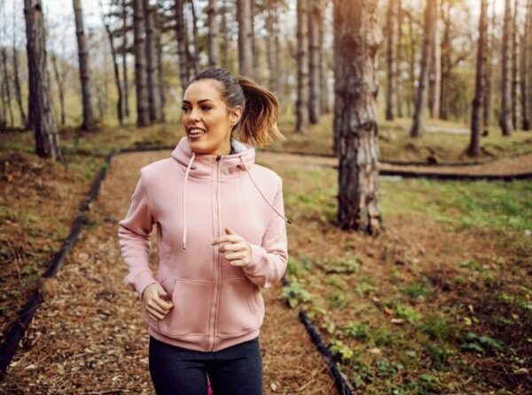 Borg scale - young woman in sportswear running in woods