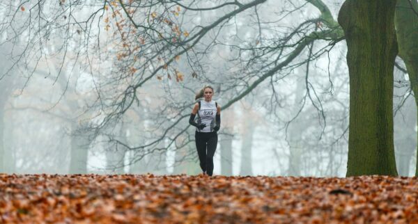 how to training for a marathon woman running in forest