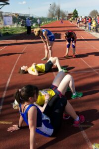 10-Informative-Training-tips - Makes-Breakthrough-In-A-Marathon-exhausted-female-runners-lies-down