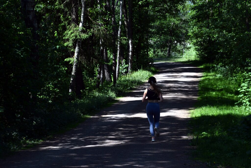 10-Informative-Training-tips - Makes-Breakthrough-In-A-Marathon-woman-running-on-a-forest-path