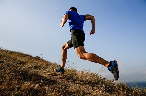marathon training for outstanding results - A runner perform long hill training.