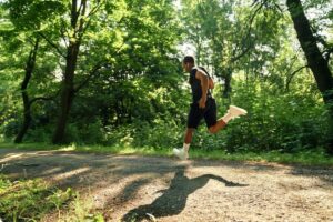 marathon training for outstanding results - A runner training fartlek on a forrest trail
