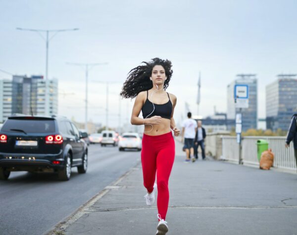 Music For Running Experiences young woman running in the city