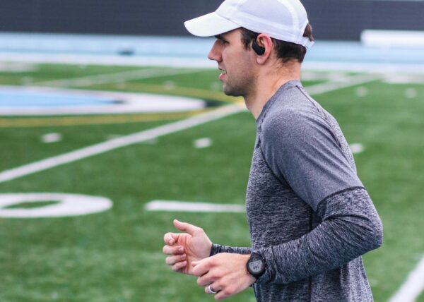 Music For Running Experiences young man running with wireless earplugs