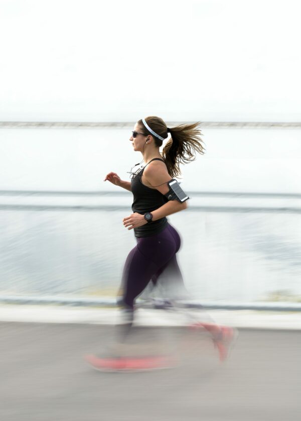 Music For Running Experiences strong woman running with earplugs