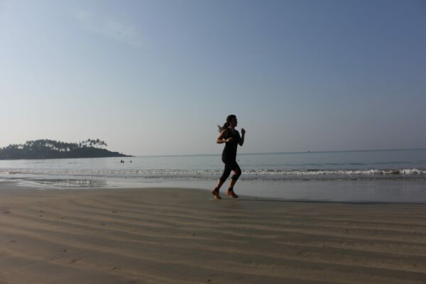 Training To Complete a Half Marathon With Great Motivation female running along the beach