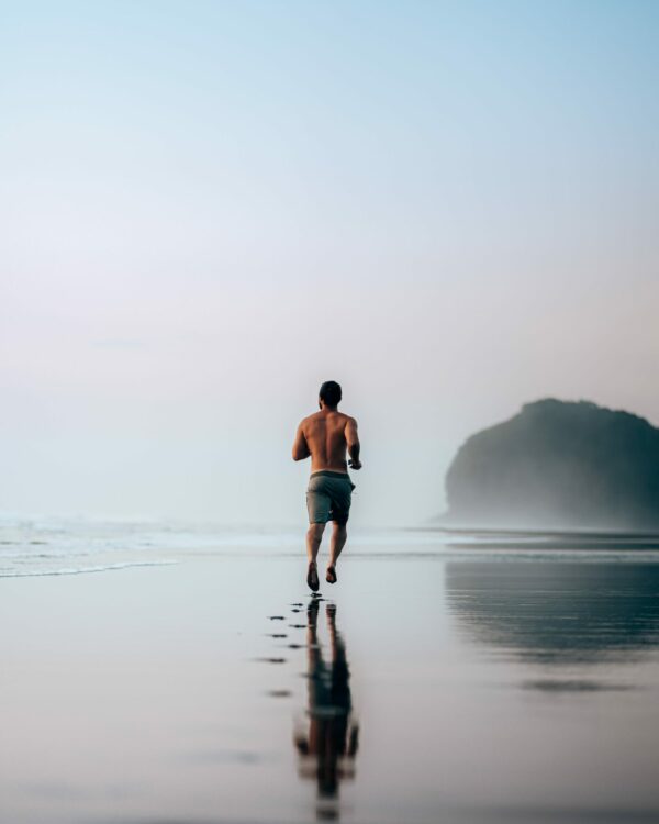 How To Run For Better Fitness Man running at the beach side