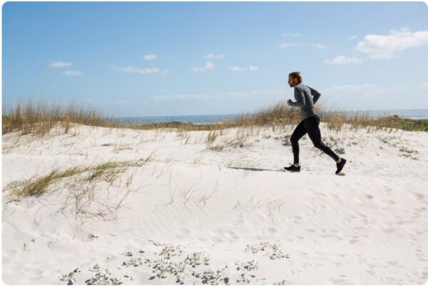Man running for better fitness at the beach
