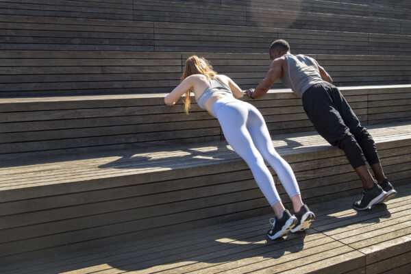 Runners performing a warm-up exercise before training