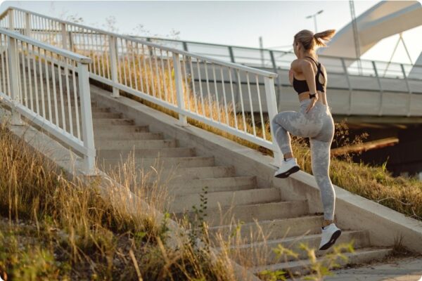 Woman running up stairs for fitness training