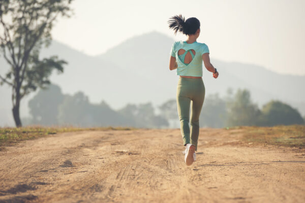 Runner on a trail using varied terrain for running training
