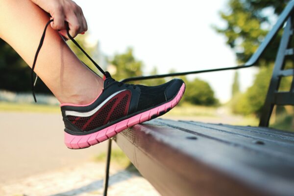 8 Best Running Tips For Beginners woman tie laces in running shoes