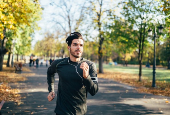Best Tips For Music to Running Training male runner with music in ear running