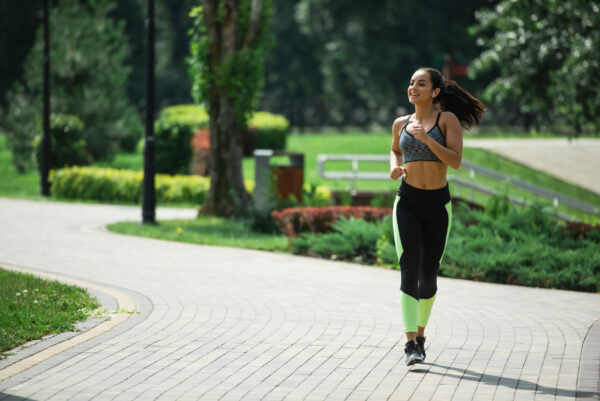 How To Start Running For Beginners The Easy Way female running with earbuds