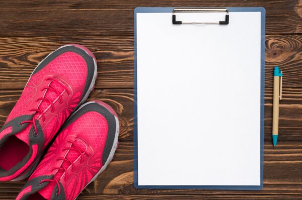 marathon training notepad with sneaker and pen