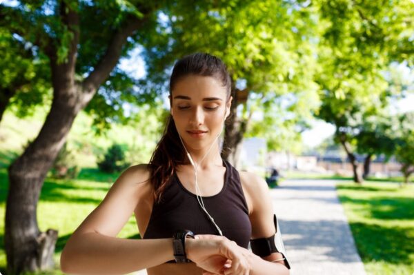 training zones - Young female runner looking at her HRM watch