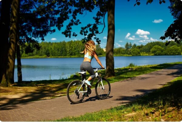 Female runner cross training by cycling at sunrise