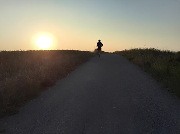 Long-distance runner on an early morning rural road