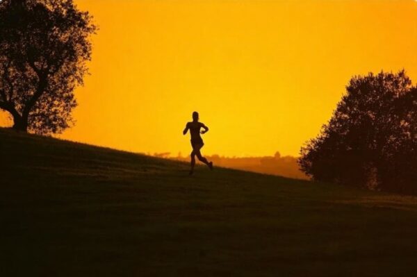 Runner in the distance approaching horizon on a scenic trail