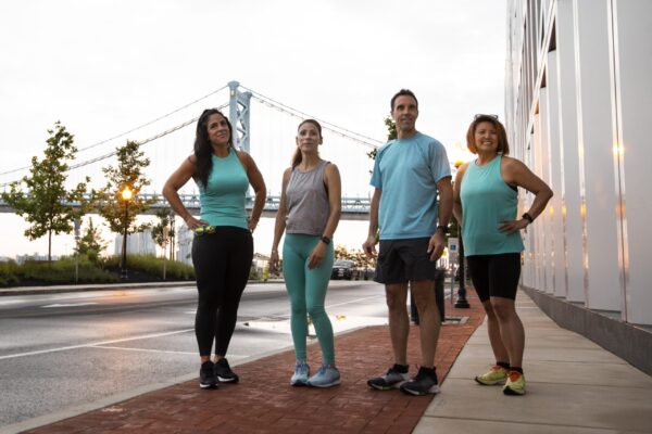 running tips for beginners - Group of runners smiling before a run