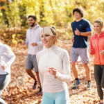 Running tips for beginners – Five cheerful runners running in forest at autumn