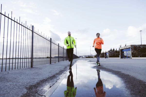 Types of marathon training - Determined runners training in challenging conditions to represent mental resilience.