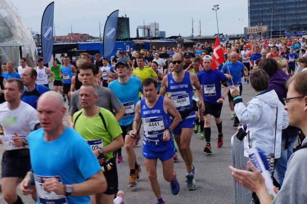 Mass marathon runners of all ages in Copenhagen Marathon, showing how marathon running evolved from elite sport to global participation
