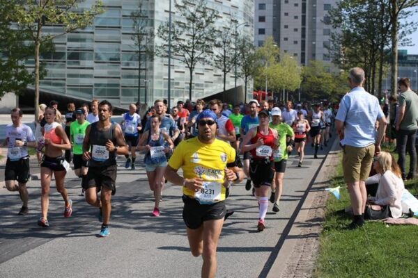 Modern marathon runners continuing the legacy of the ancient marathon legend across generations